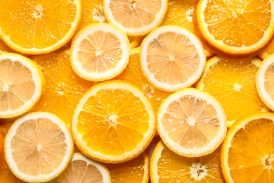 Photo of Slices of citrus fruits as background, top view