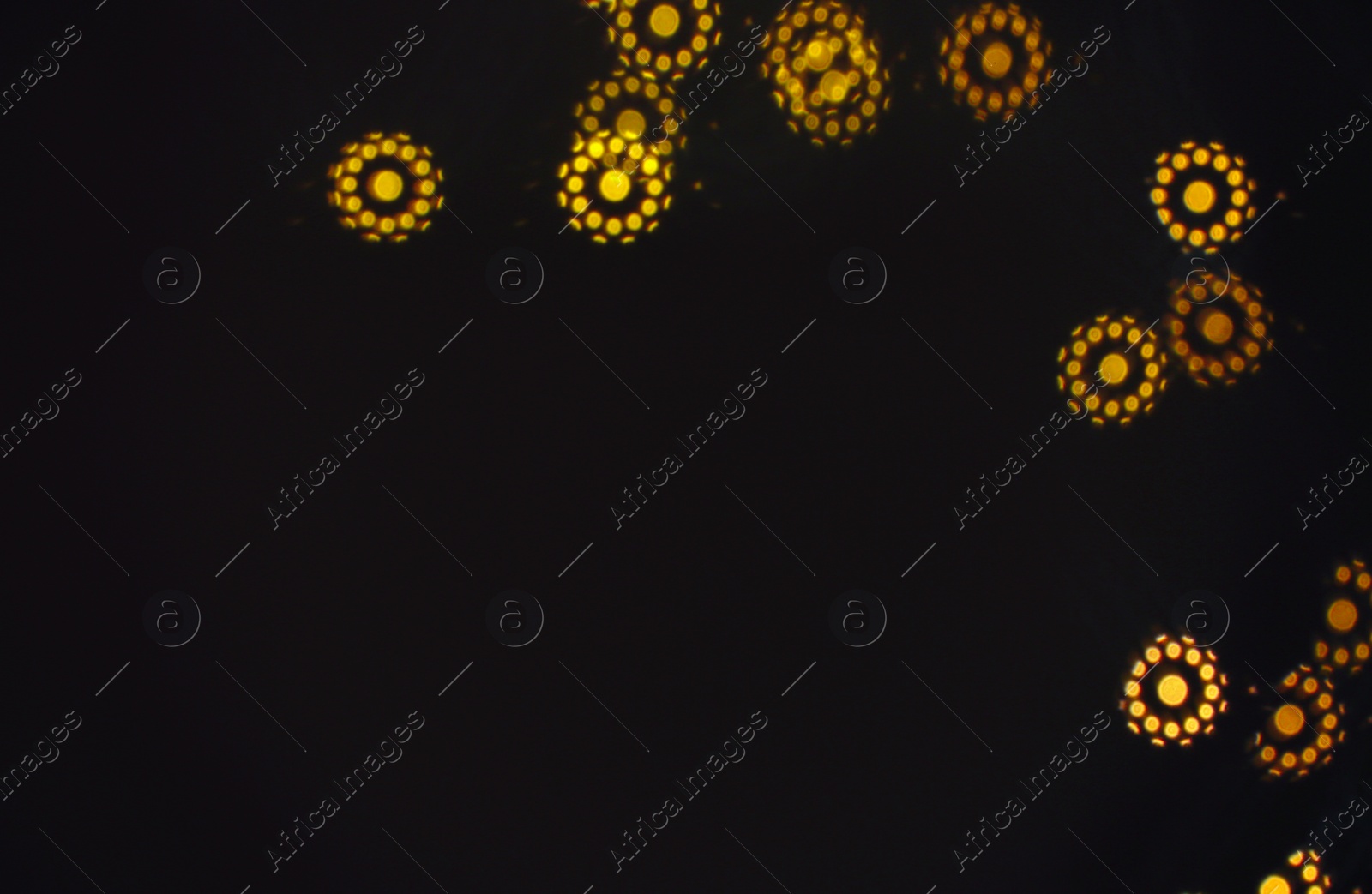 Photo of Beautiful blurred lights on dark background, bokeh effect. Space for text