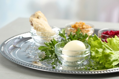 Photo of Traditional Passover (Pesach) Seder plate with symbolic meal on table indoors, space for text
