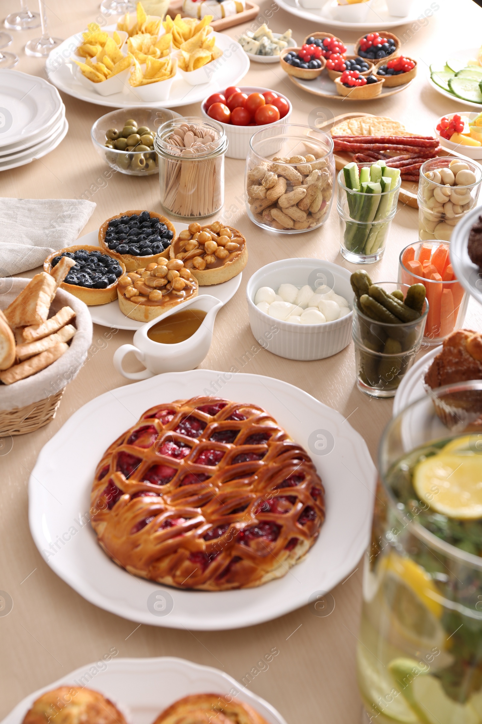 Photo of Variety of snacks on wooden table in buffet style