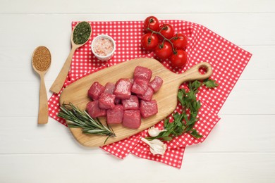 Photo of Raw beef meat and different ingredients for cooking delicious goulash on white wooden table, flat lay