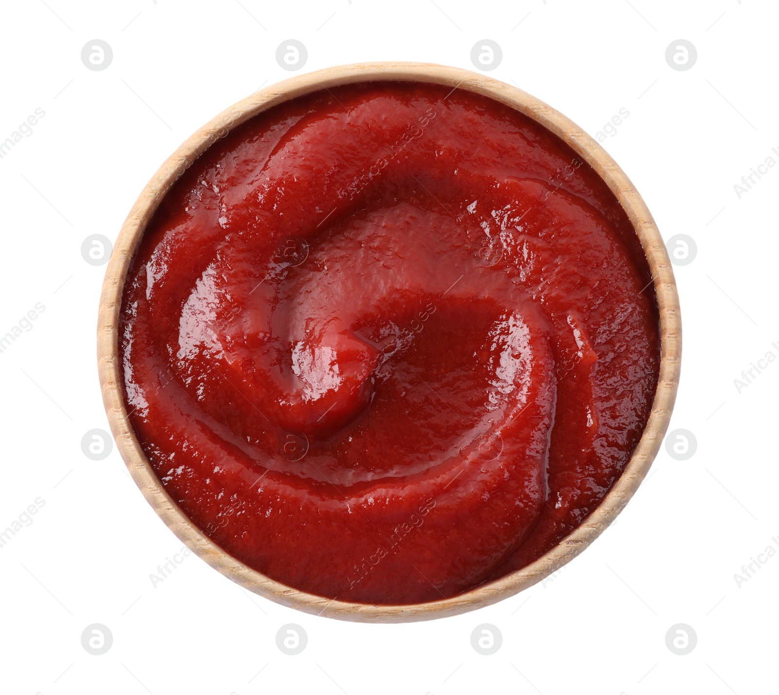 Photo of Tasty ketchup in wooden bowl isolated on white, top view