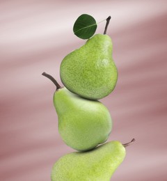 Image of Fresh ripe pears on dusty pink gradient background