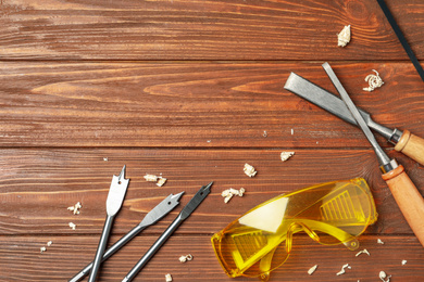 Flat lay composition with carpenter's tools on wooden background. Space for text