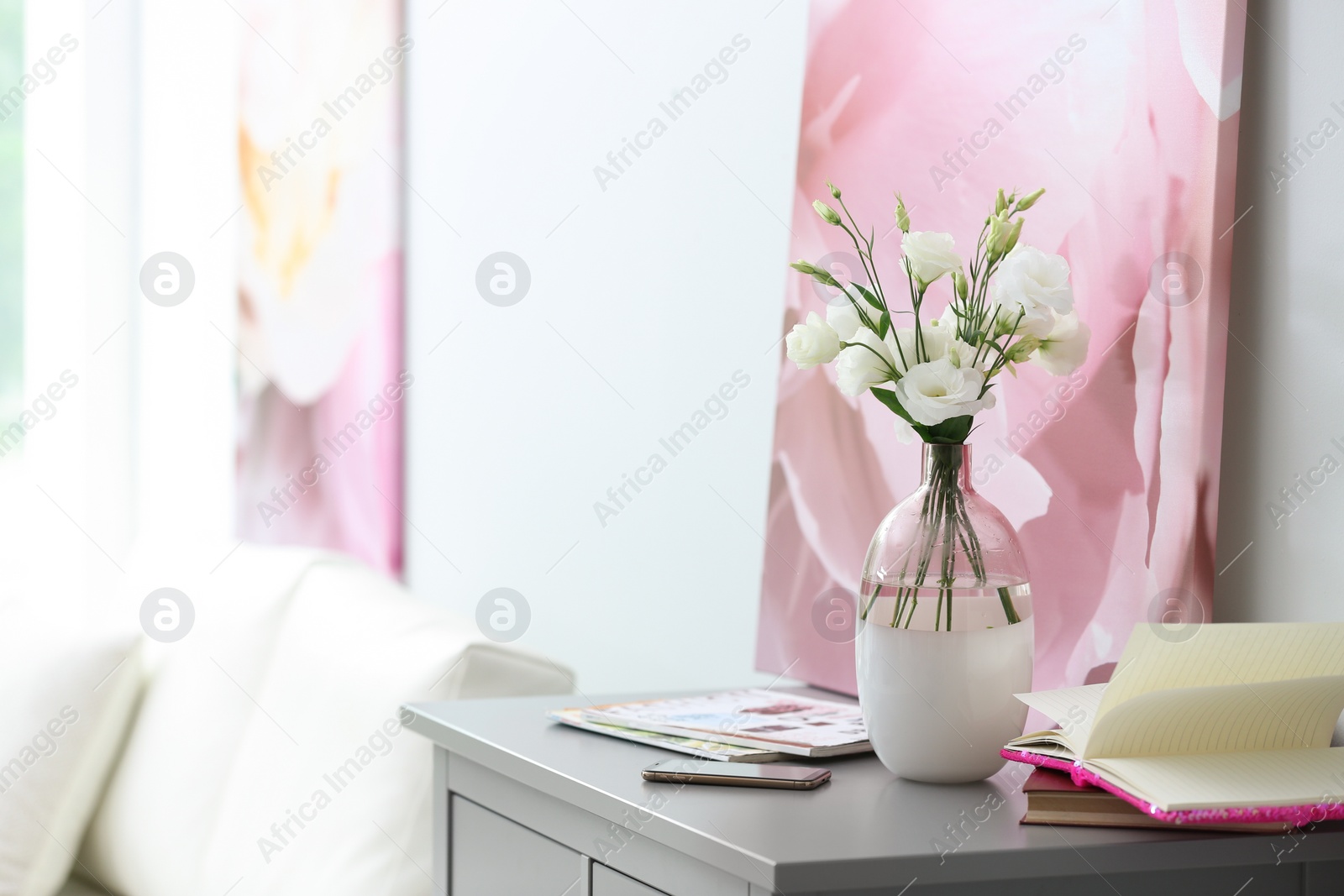 Photo of Composition of stylish vase with fresh flowers on grey table in living room. Space for text
