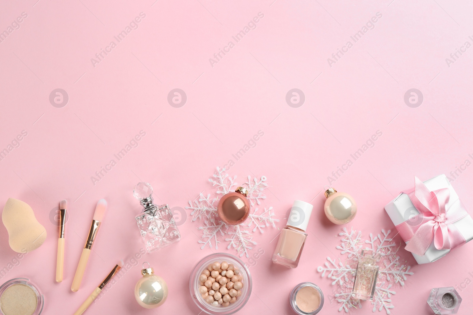 Photo of Flat lay composition with decorative cosmetic products on pink background, space for text. Winter care