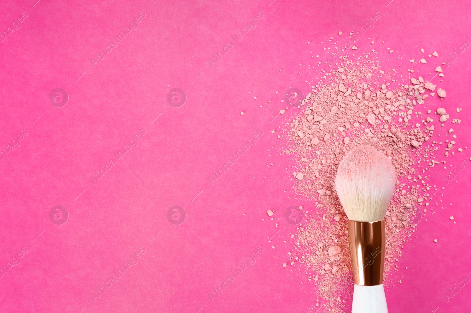 Photo of Makeup brush and scattered blush on bright pink background, top view. Space for text