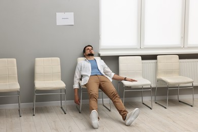 Photo of Tired man waiting for job interview indoors