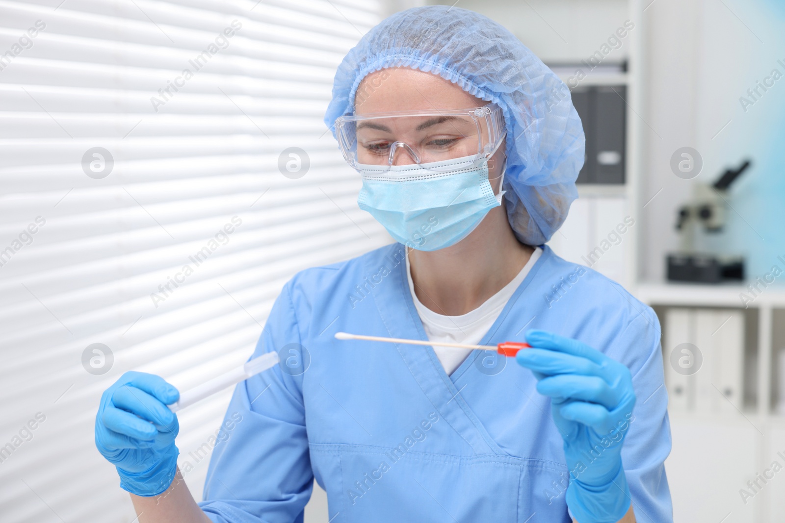 Photo of Laboratory testing. Doctor with cotton swab and tube in hospital