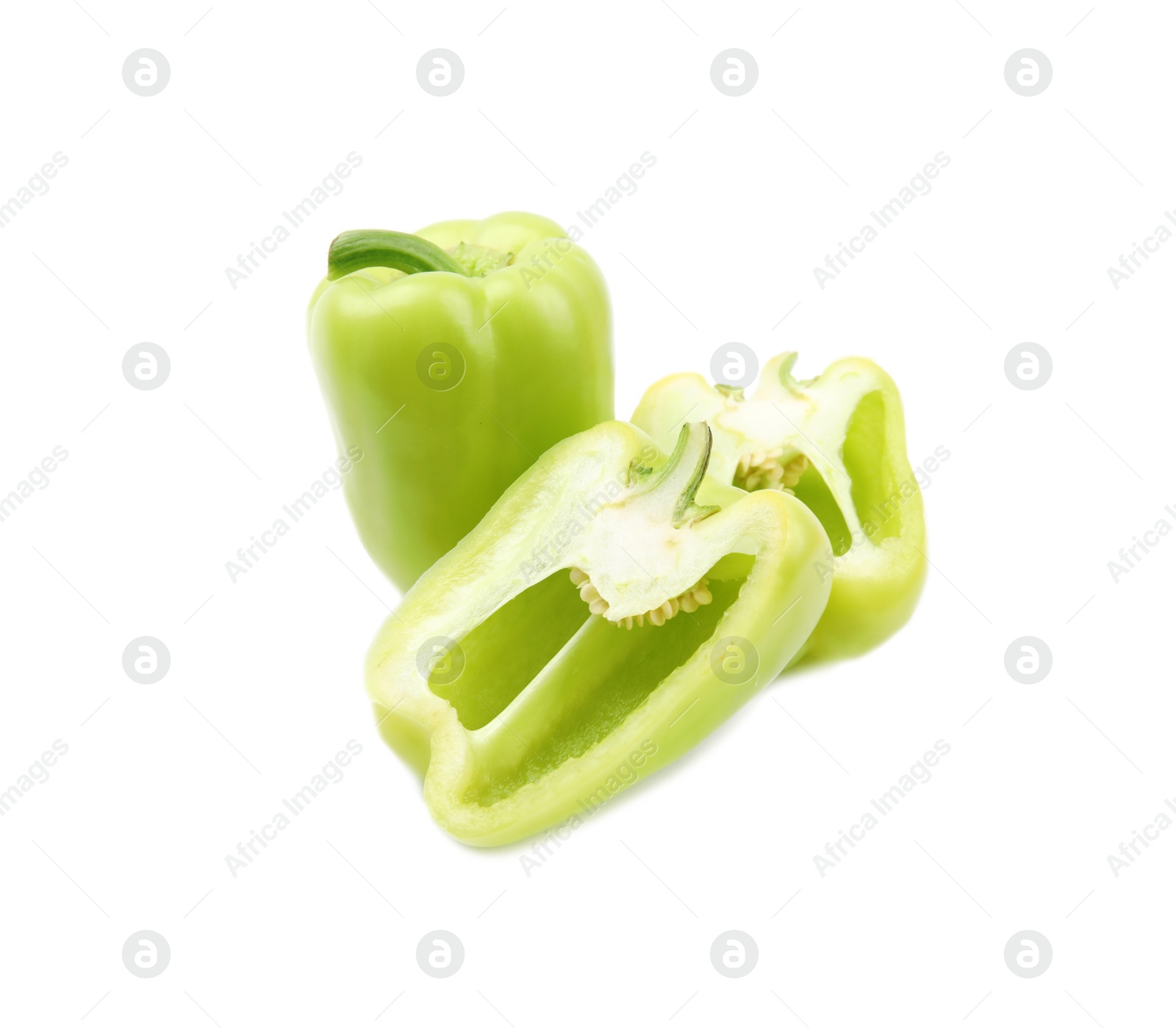 Photo of Whole and cut green bell peppers on white background