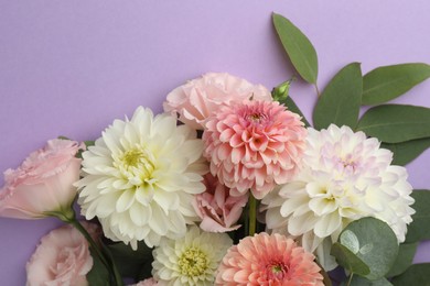 Photo of Bouquet of beautiful fresh flowers on violet background, top view