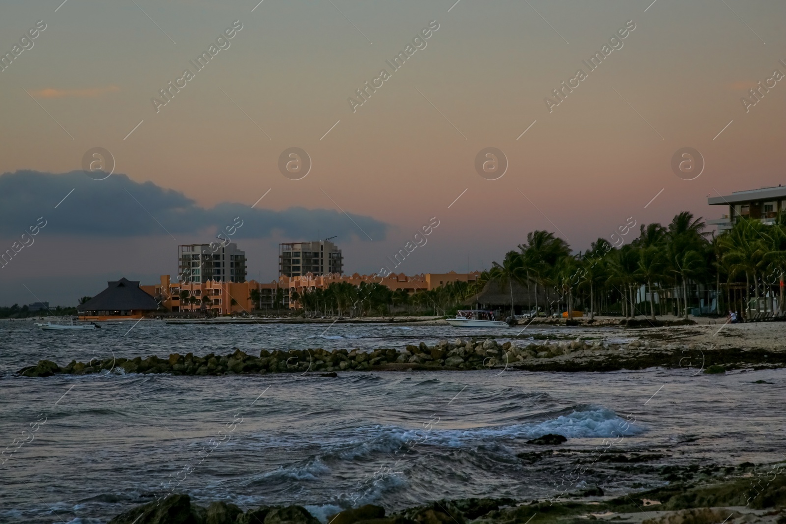 Photo of Picturesque view of sea and tropical resort at beautiful sunset