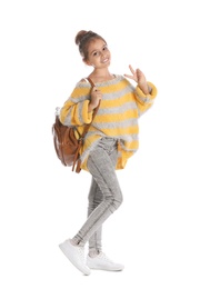 Pretty preteen girl with backpack against white background