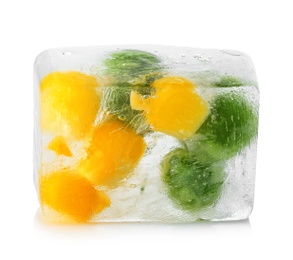 Photo of Corn grains and green peas in ice cube on white background. Frozen vegetables