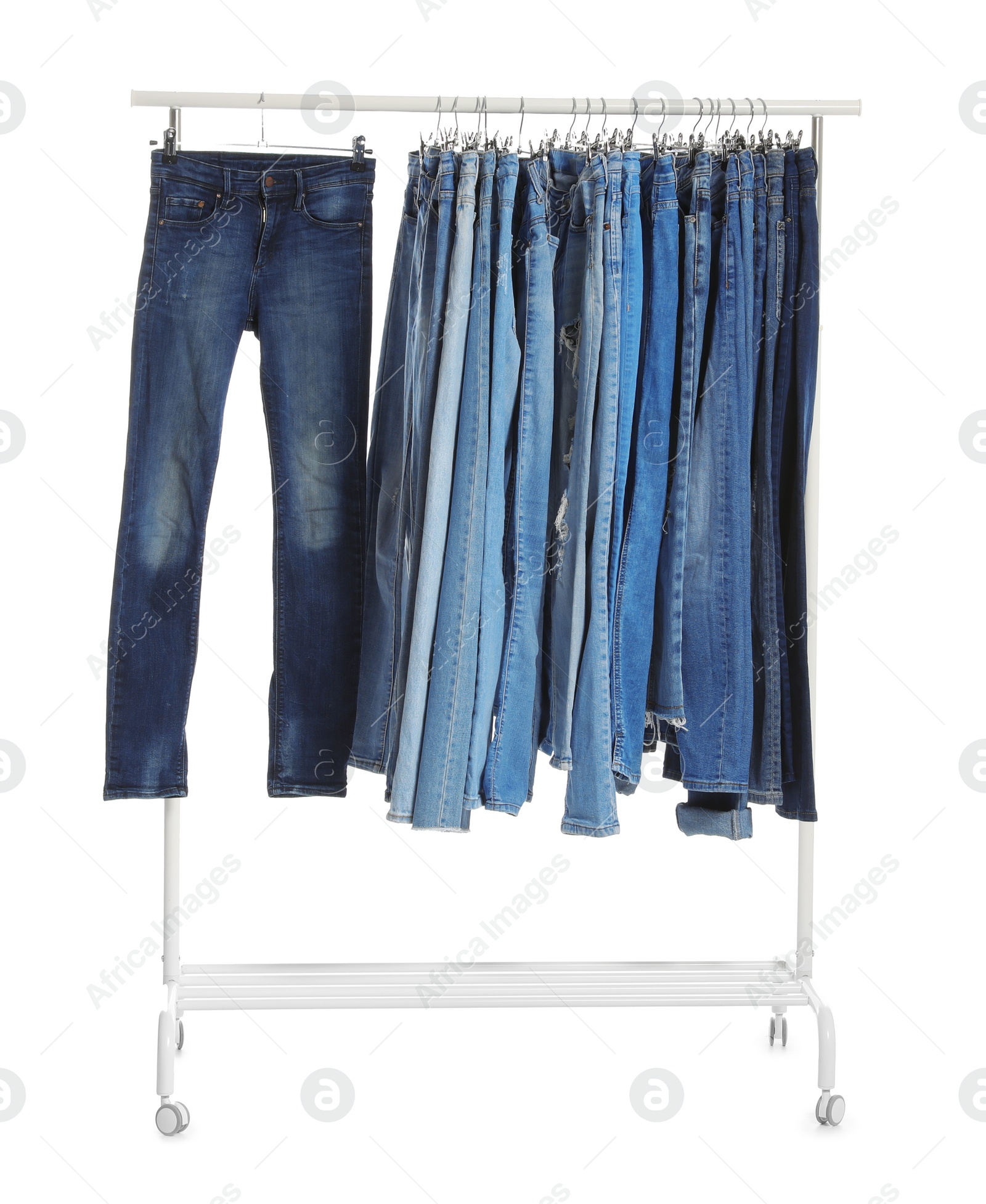 Photo of Rack with different jeans isolated on white