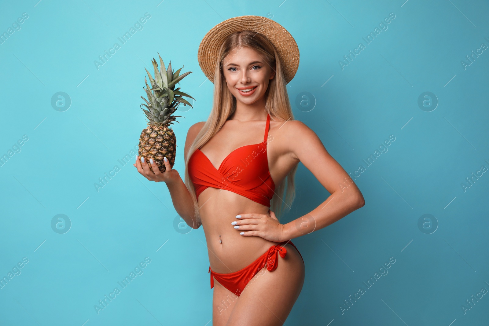 Photo of Pretty young woman wearing stylish bikini with pineapple on blue background