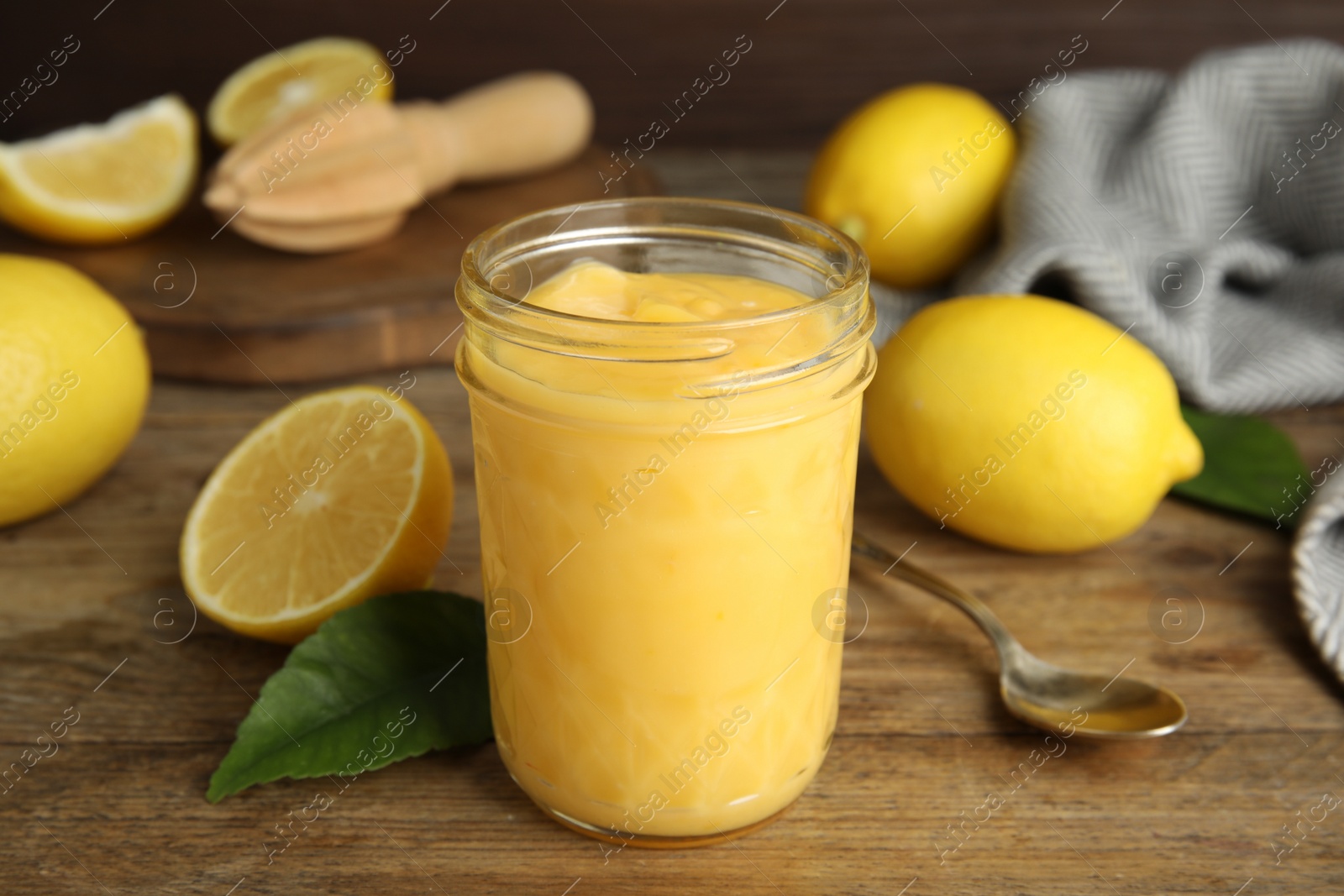 Photo of Delicious lemon curd and fresh fruits on wooden table