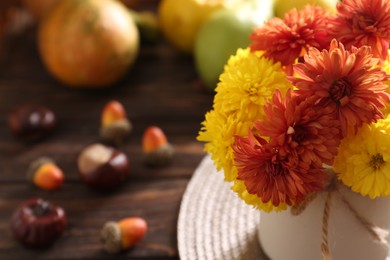 Photo of Beautiful colorful chrysanthemum flowers on wooden table, closeup. Space for text