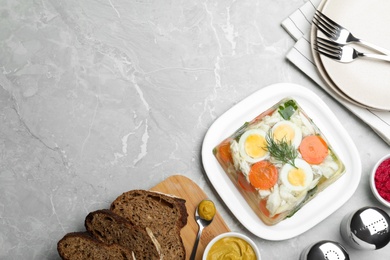 Photo of Delicious fish aspic served on grey marble table, flat lay. Space for text