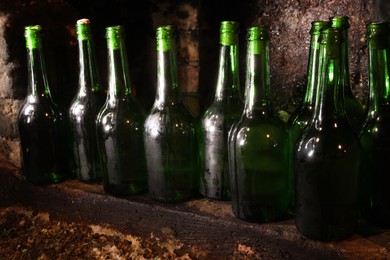 Photo of Many bottles of alcohol drinks on shelf in cellar