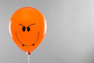 Photo of Spooky balloon for Halloween party on light grey background, space for text