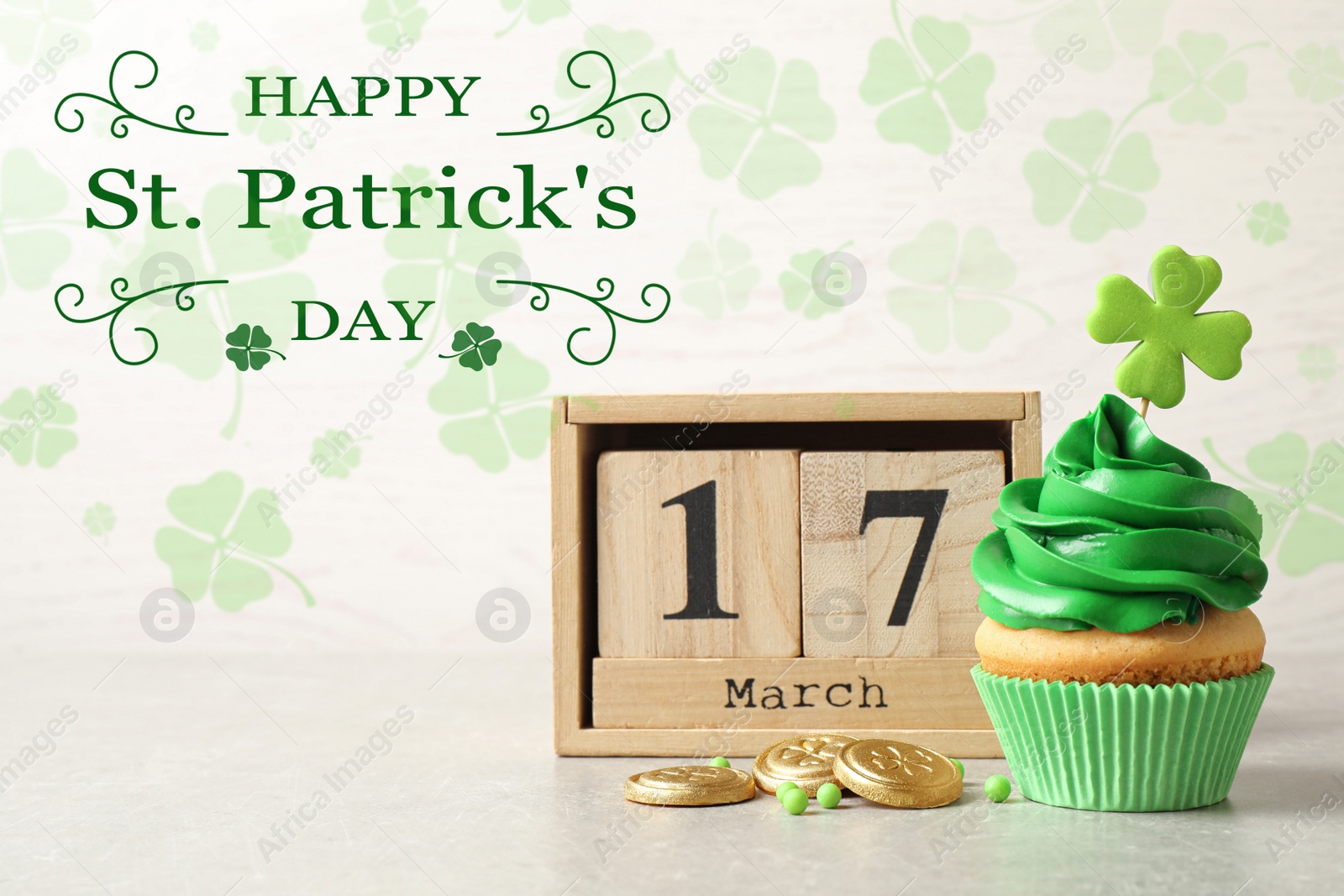 Image of Delicious decorated cupcake, wooden block calendar and coins on light table. St. Patrick's Day celebration