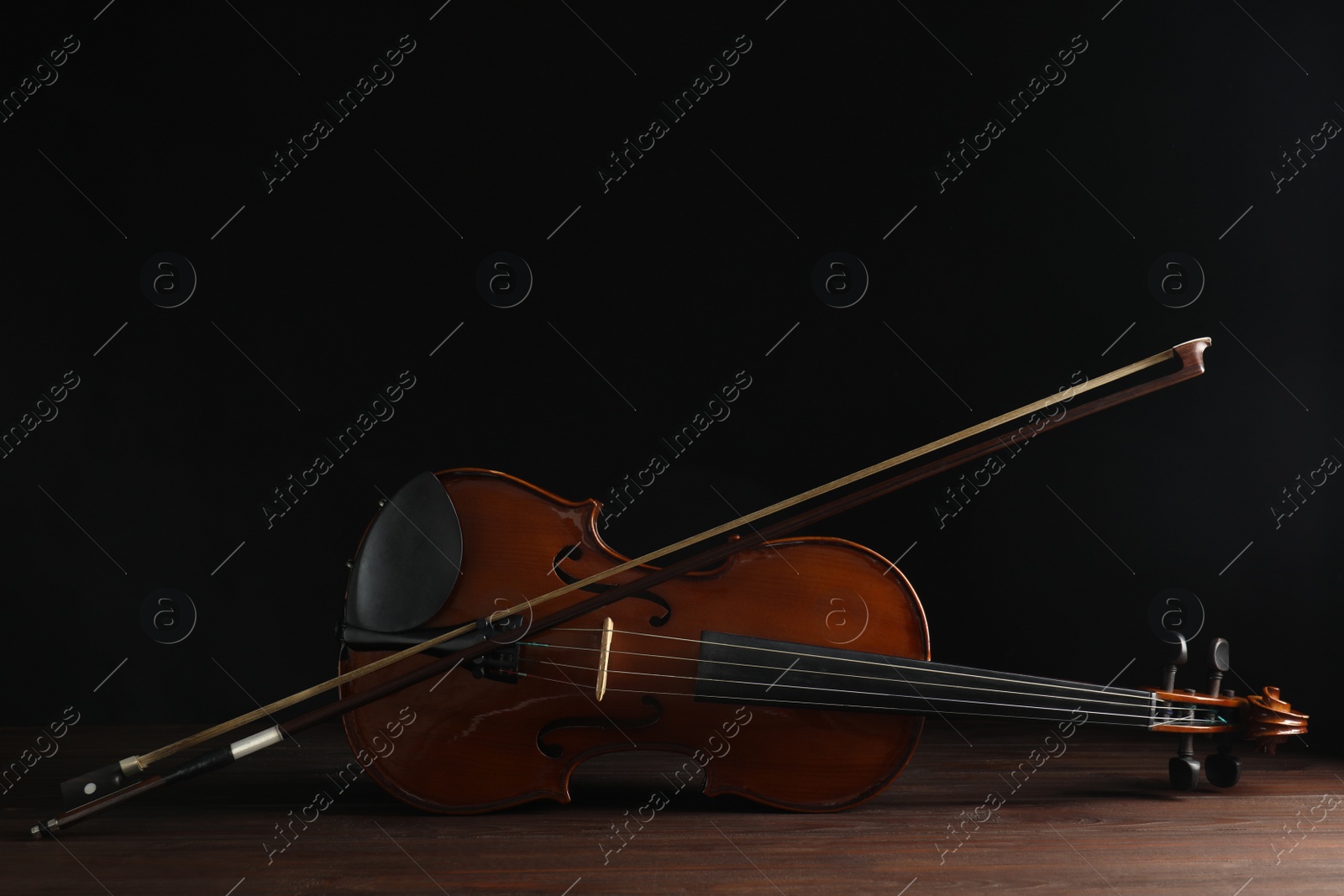 Photo of Classic violin and bow on wooden background