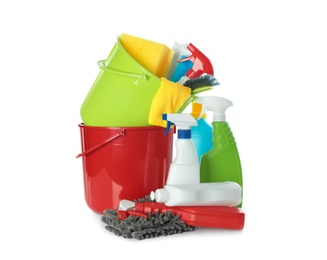 Plastic buckets and different cleaning supplies on white background