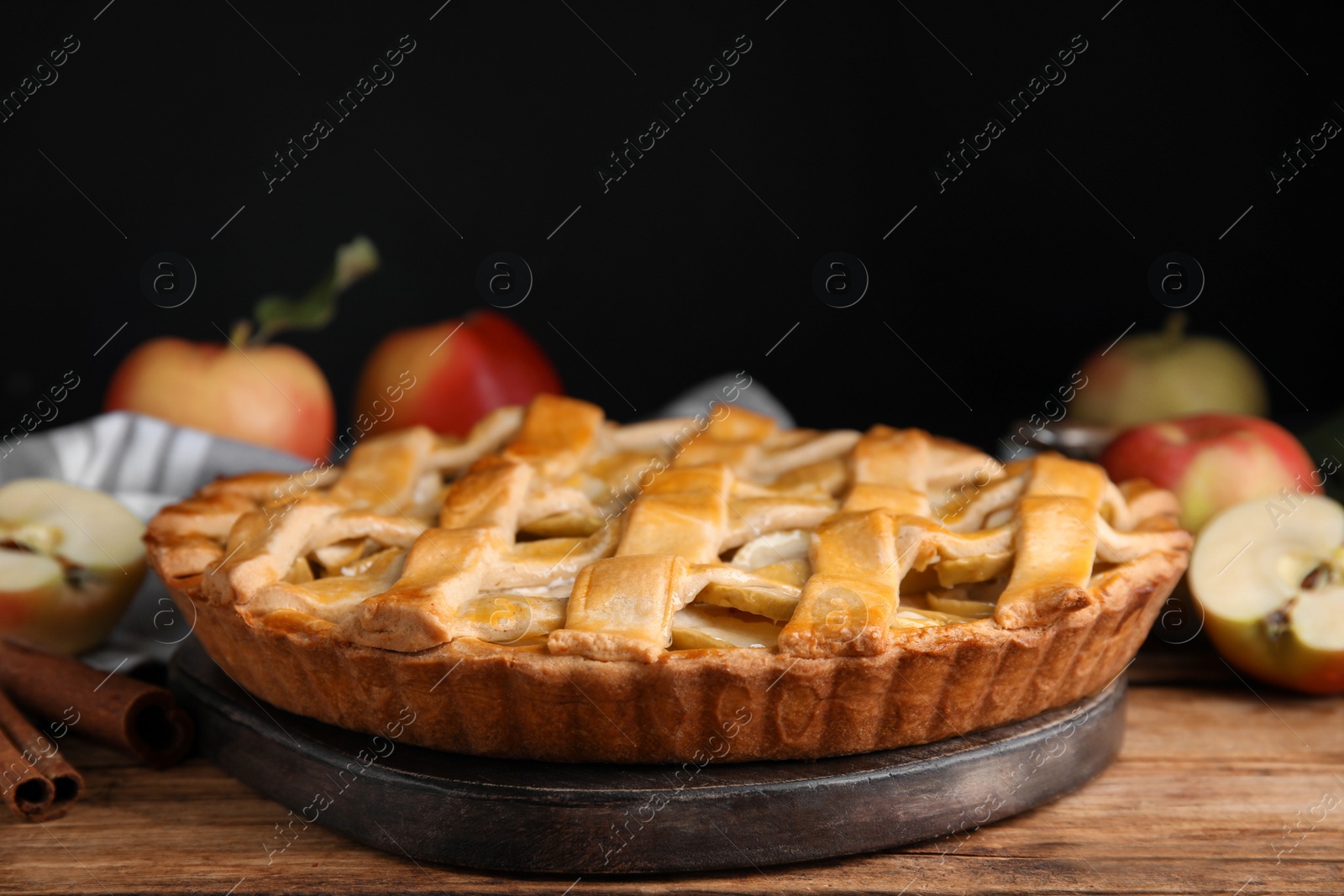 Photo of Delicious traditional apple pie on wooden table