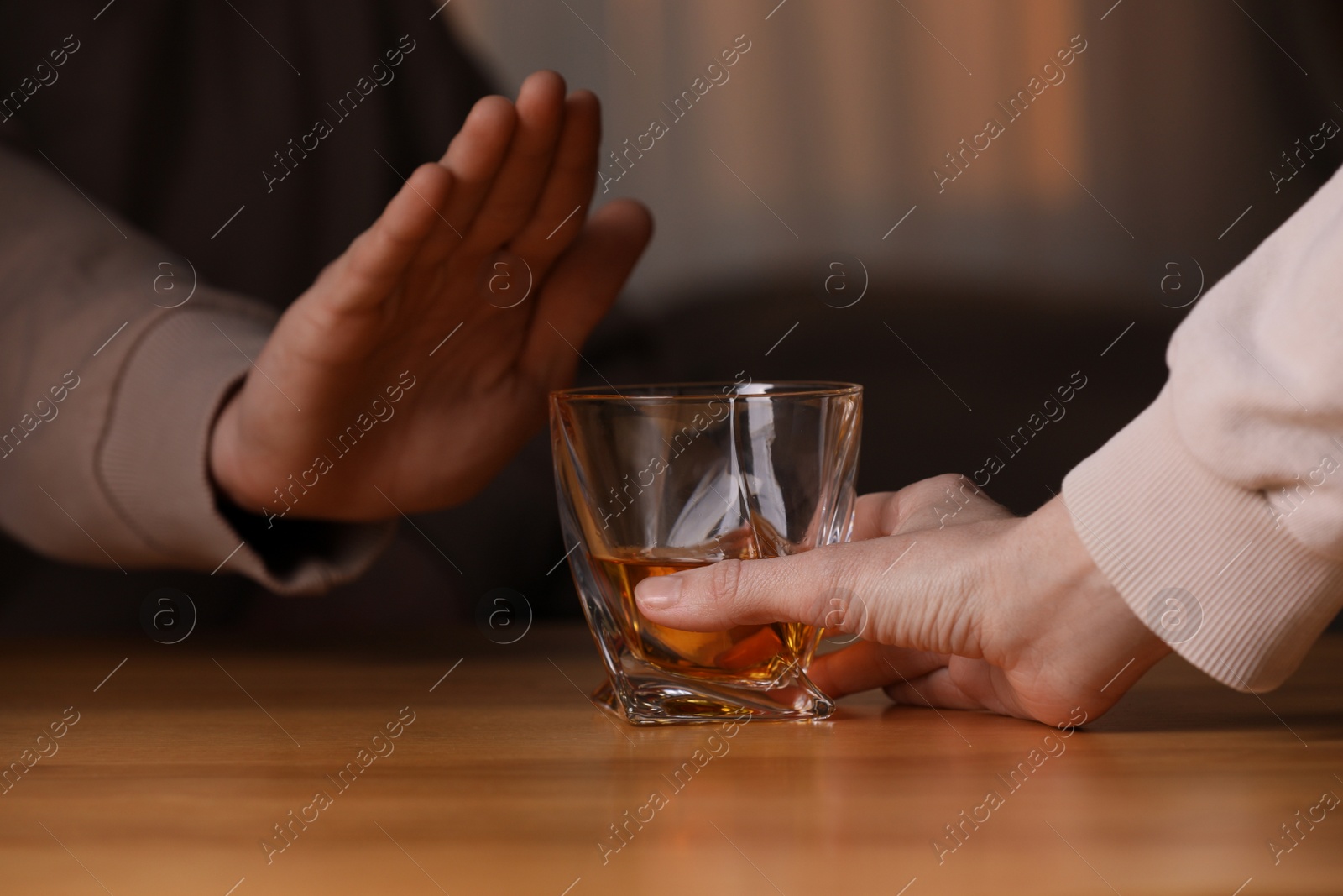 Photo of Man refusing to drink whiskey indoors, closeup. Alcohol addiction treatment