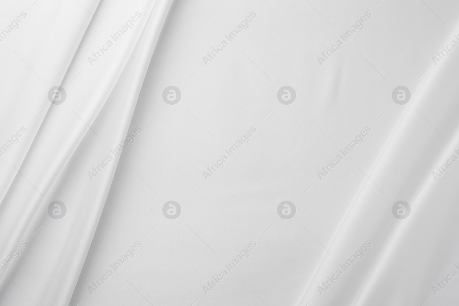 Photo of Texture of crumpled white silk fabric as background, top view. Space for text