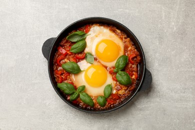 Photo of Delicious Shakshuka on light grey table, top view
