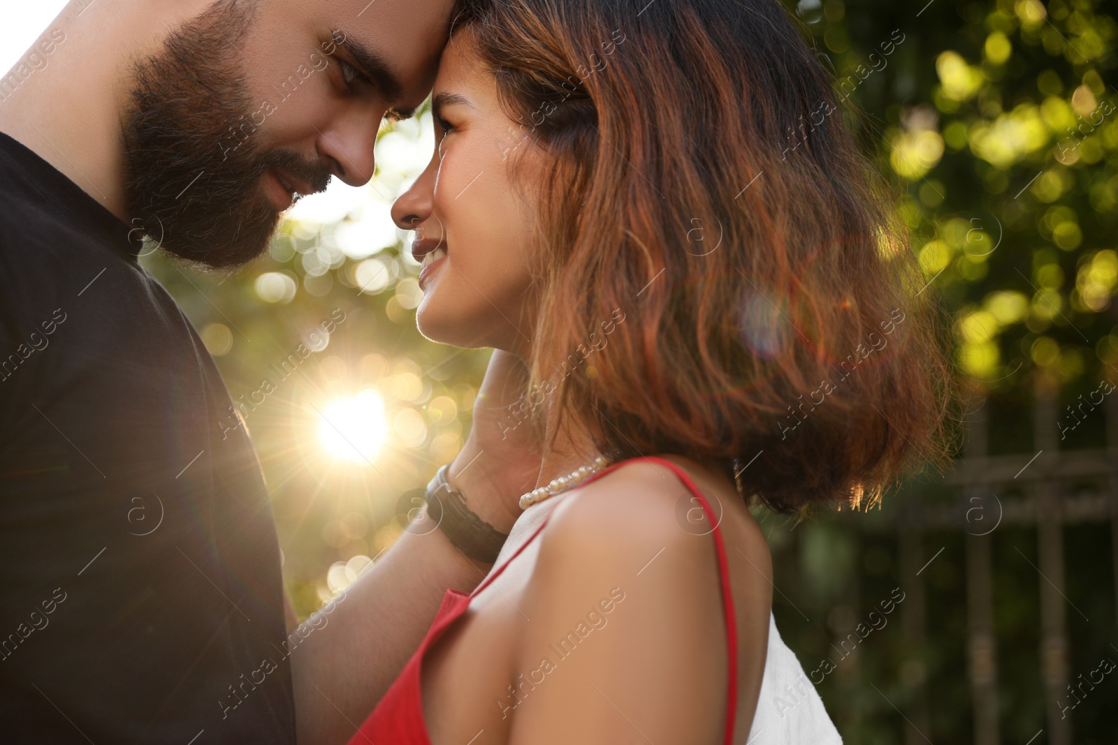 Photo of Happy young couple together in sunlight outdoors