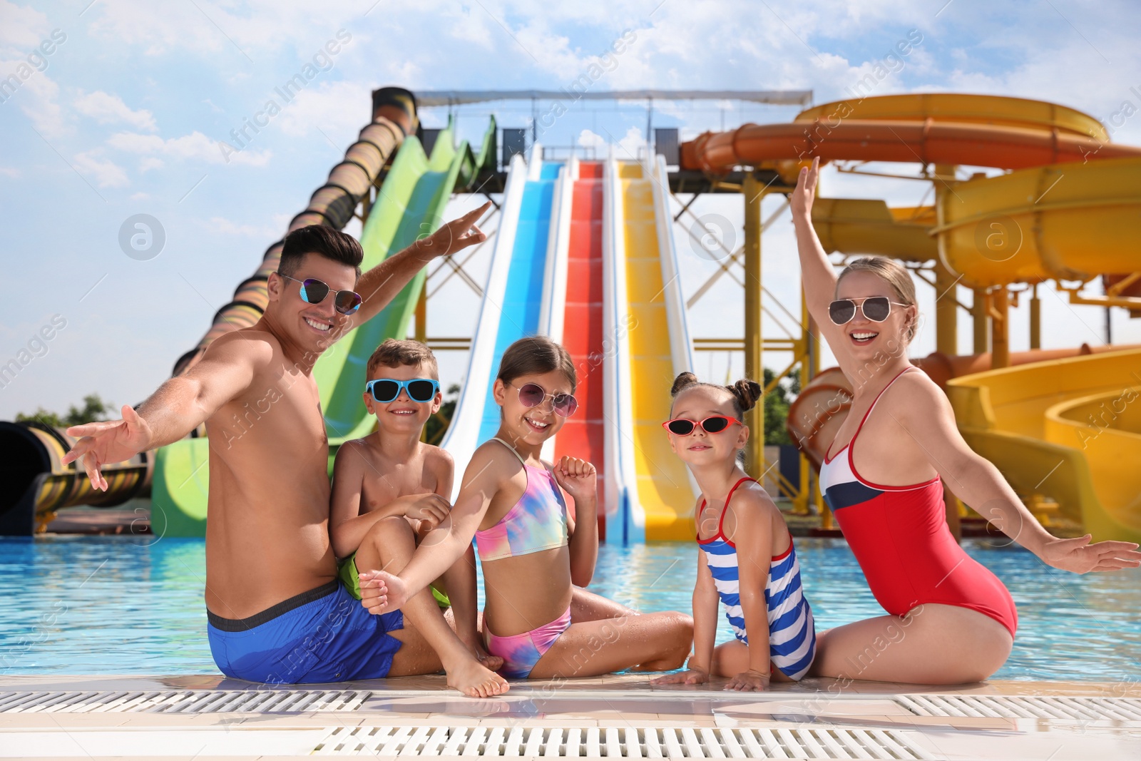 Photo of Happy family at poolside in water park