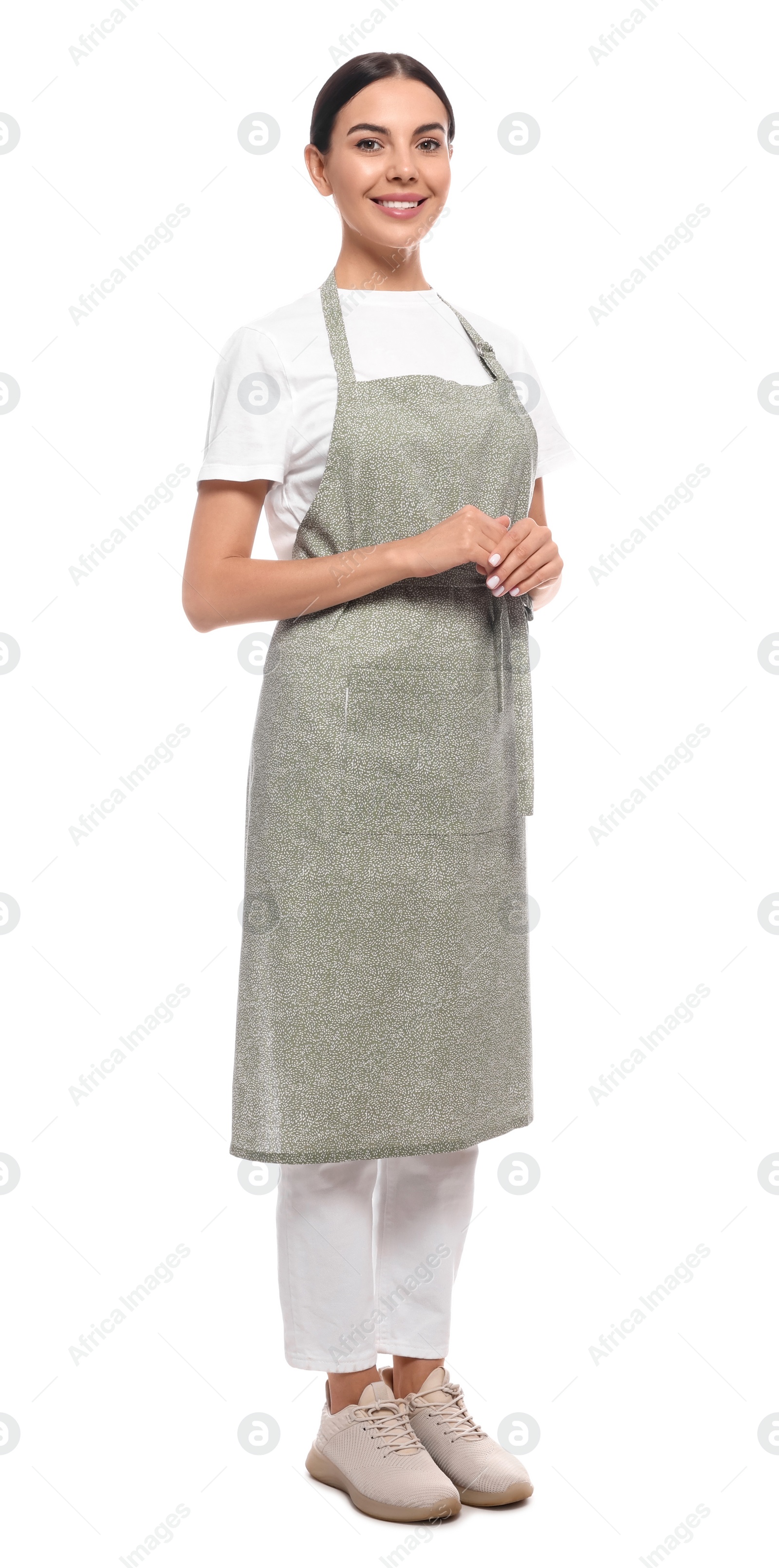 Photo of Young woman in light green apron on white background