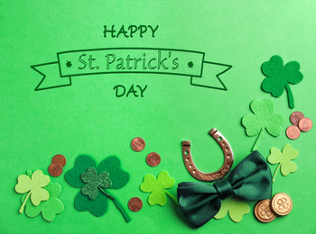 Image of Flat lay composition with horseshoe on green background. St. Patrick's Day celebration