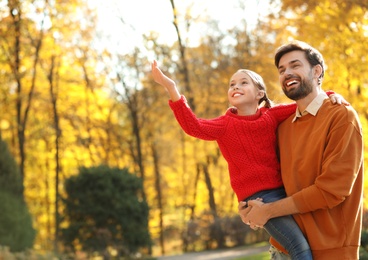 Photo of Happy father and daughter spending time in park. Autumn walk