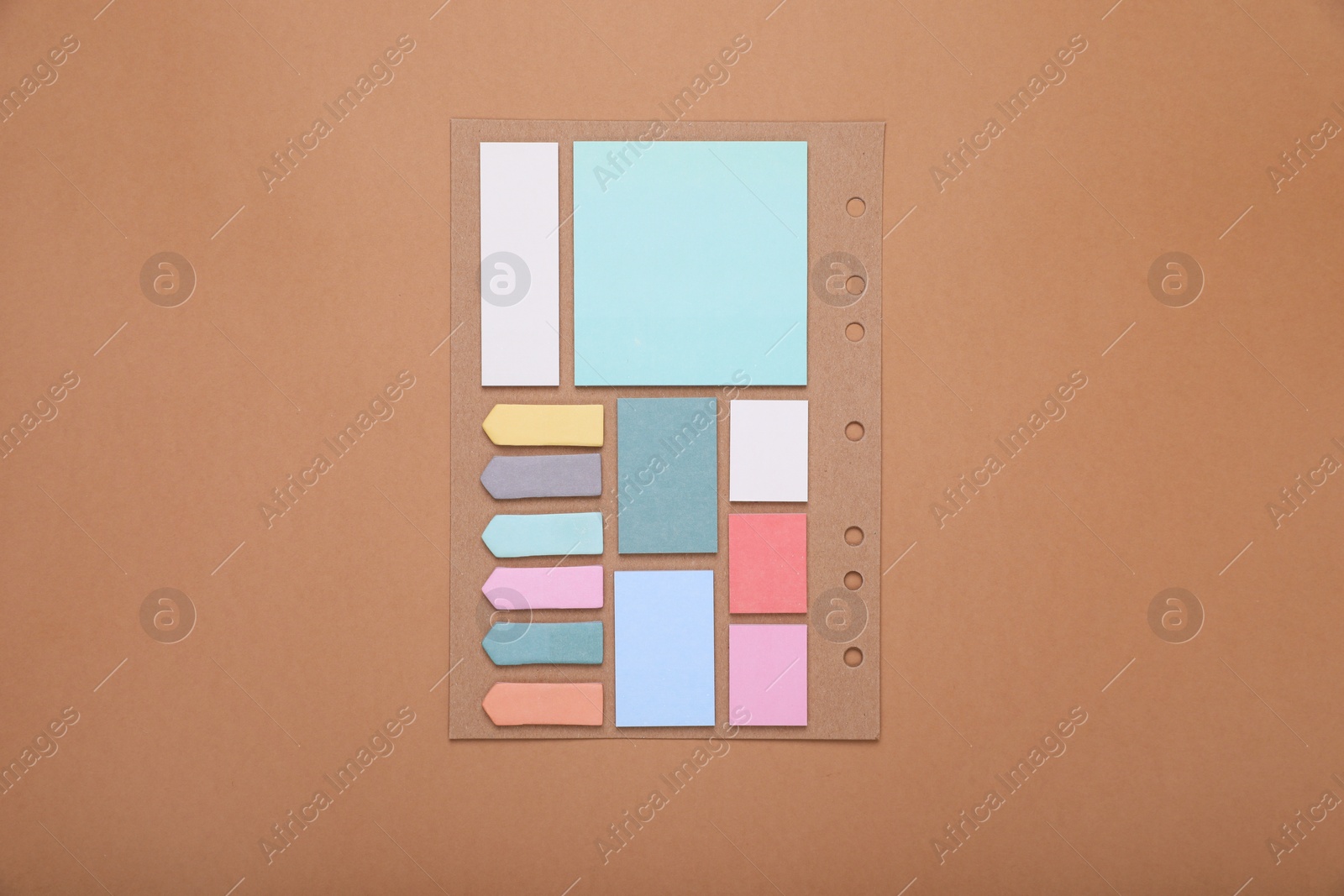 Photo of Set of different sticky notes for planner on brown background, top view