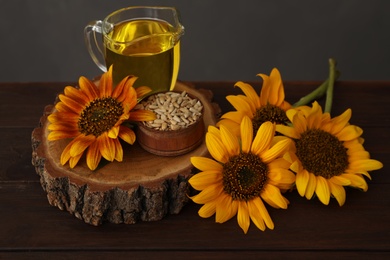 Photo of Composition with sunflower oil on wooden table