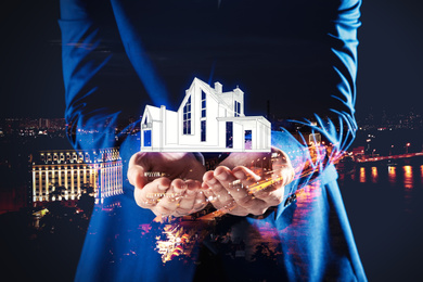 Image of Double exposure of real estate agent with house illustration and night city