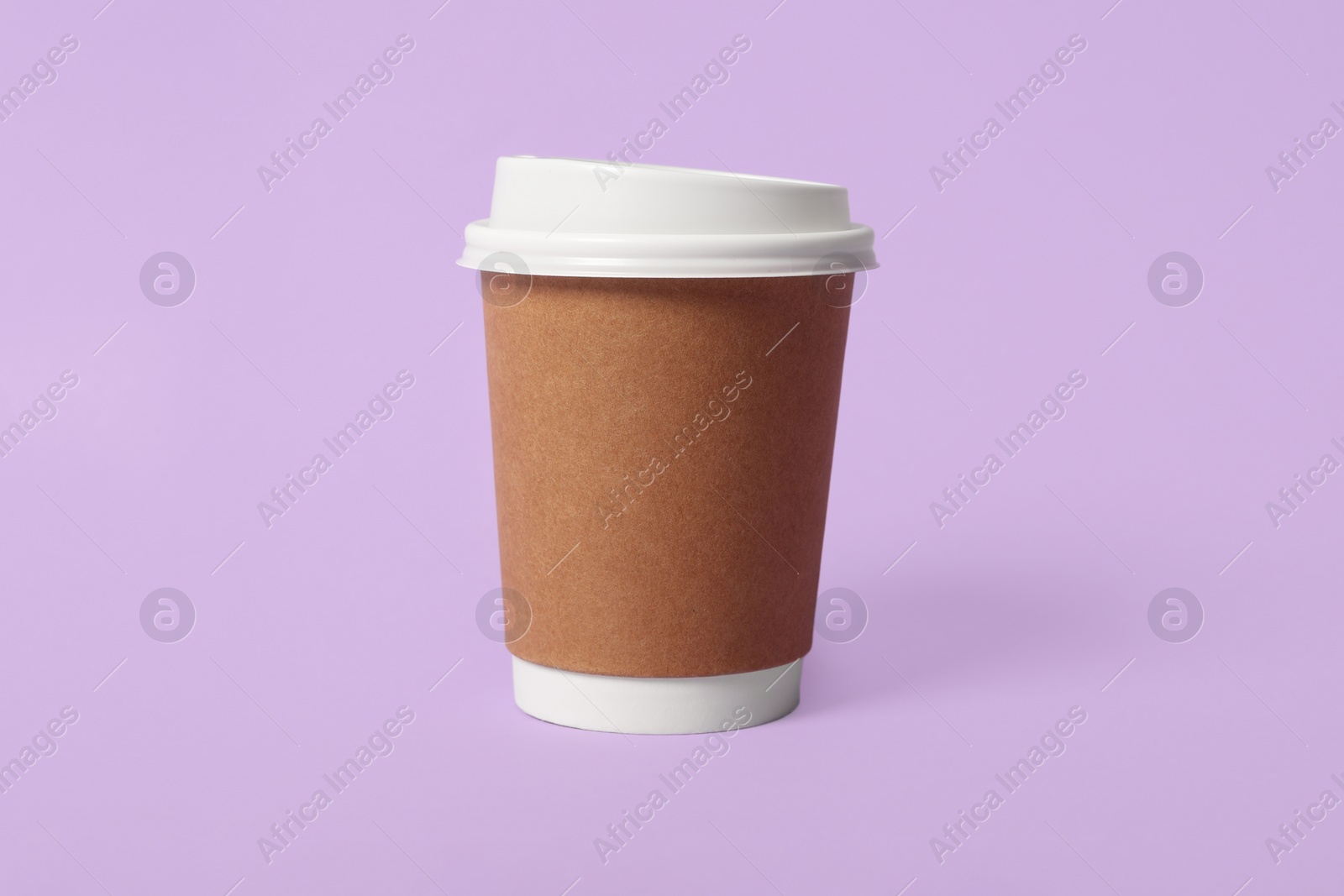 Photo of Takeaway paper coffee cup on violet background
