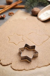 Homemade Christmas biscuits. Dough and cookie cutter on table, closeup