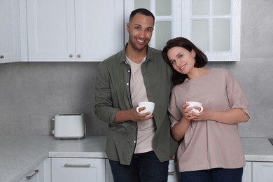 Photo of Dating agency. Happy couple spending time together in kitchen, space for text