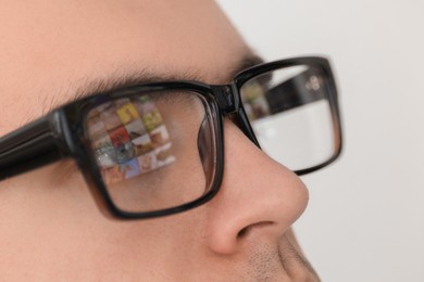 Photo of Man wearing glasses on light background, closeup