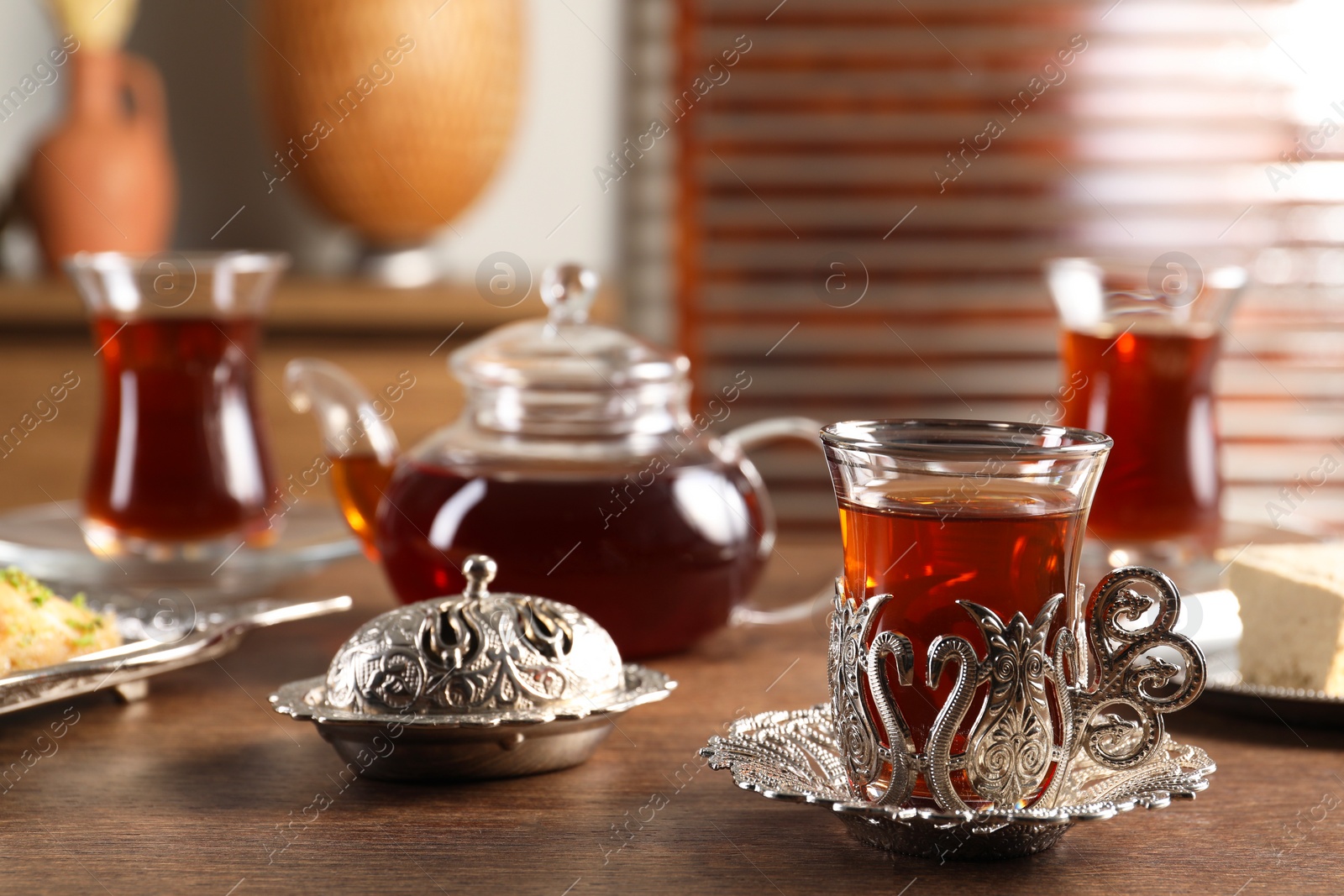 Photo of Traditional Turkish tea served in vintage tea set on wooden table