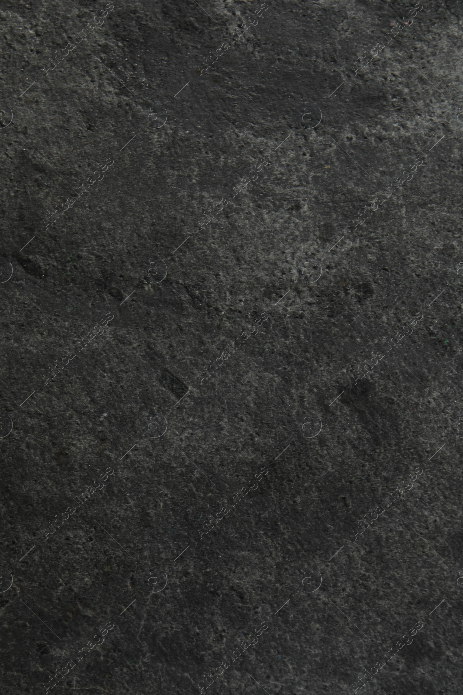 Photo of Texture of dark grey stone surface as background, closeup