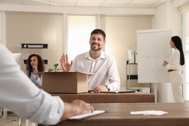 New coworker greeting employee in modern office