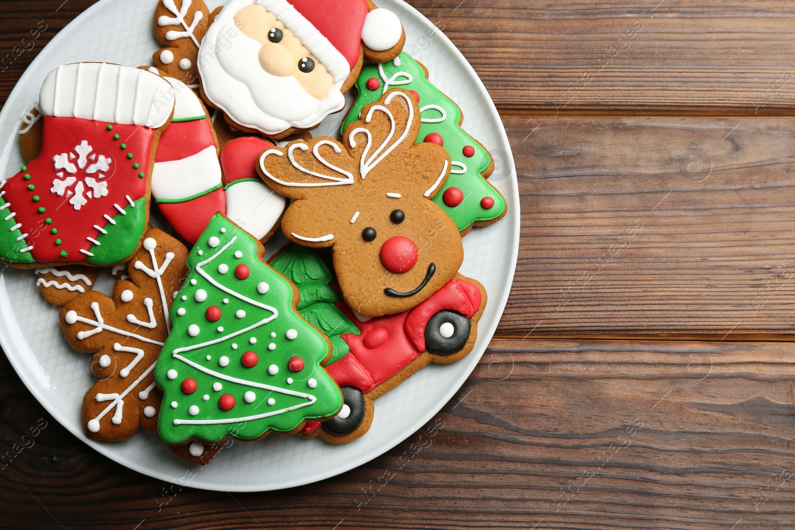 Photo of Different tasty Christmas cookies on wooden table, top view. Space for text