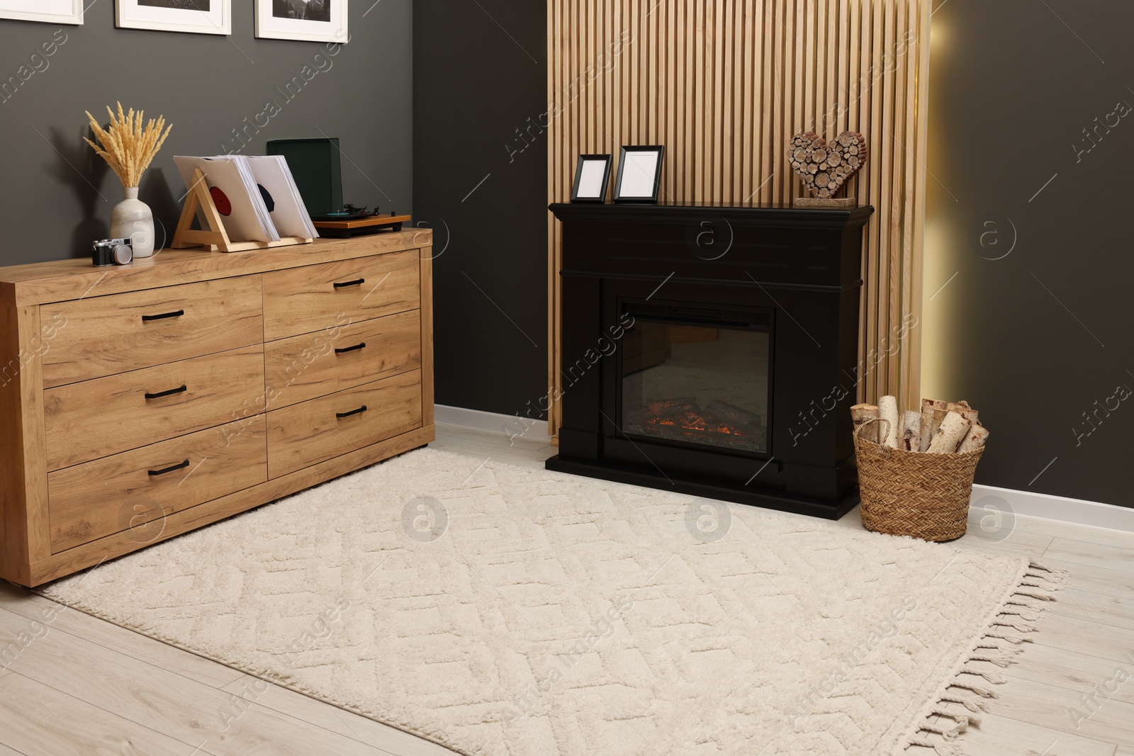 Photo of Stylish room with beautiful rug near fireplace. Interior design