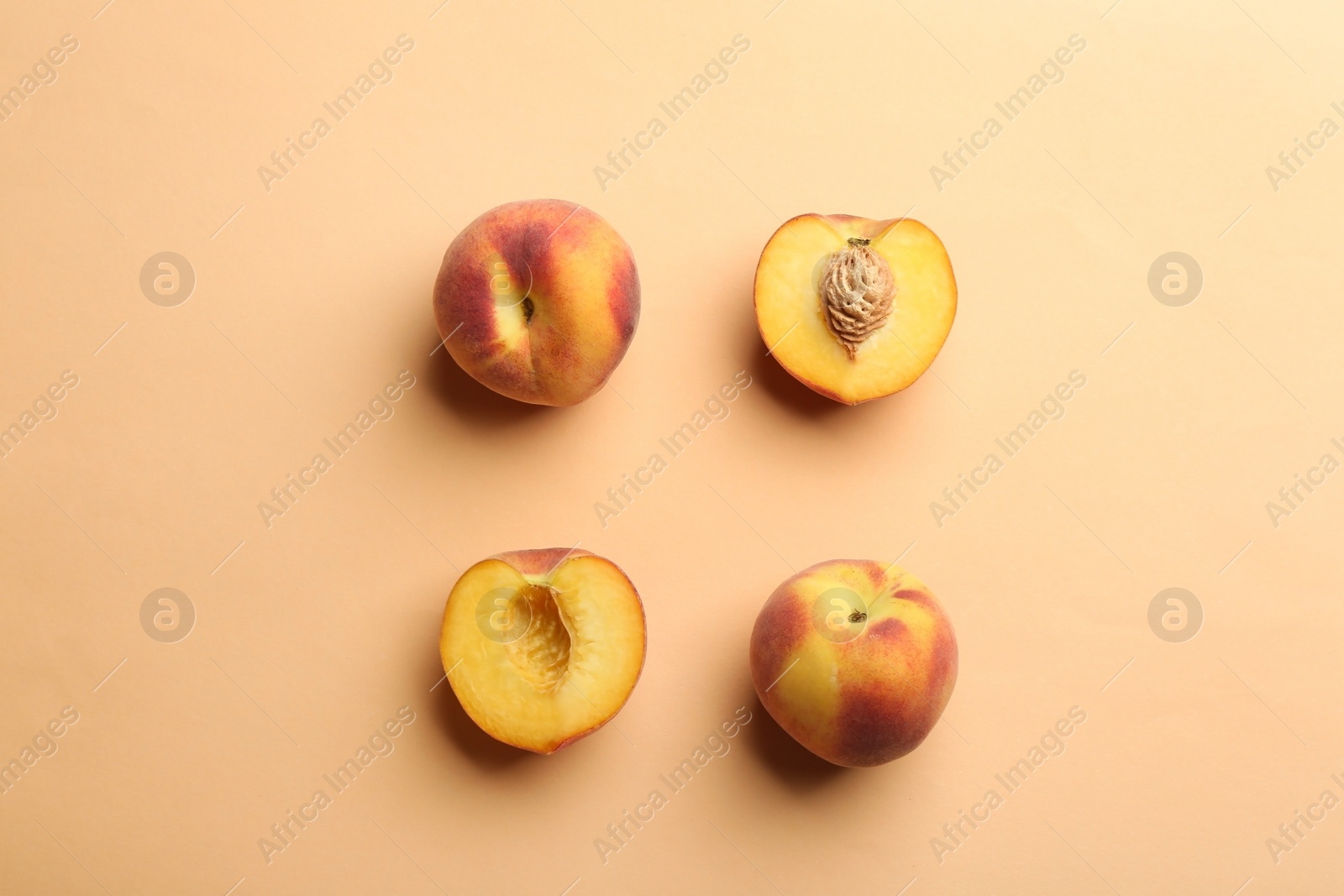 Photo of Flat lay composition with fresh peaches on beige background